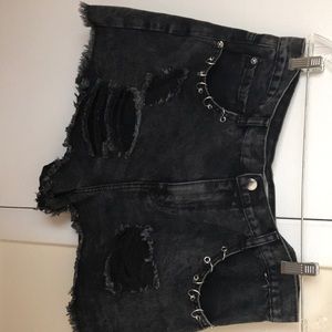 black jean shorts with silver rings on the side
